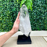 Side view of Polished Lemurian Quartz Point with Stand showing natural crystal details