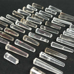 Close-up of Clear Quartz Vogel 50 pieces Lot with visible color and formation