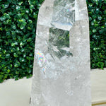 Close-up of Polished Lemurian Quartz Point with Stand with visible color and formation