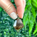 Close-up of Phantom Quartz Pendant - HQ Brown Phantom Pendants Lot with visible color and formation