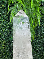Close-up of Polished High Quality Lemurian Quartz Point with Stand with visible color and formation