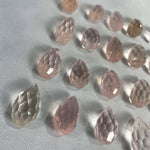 Close-up of Rose Quartz Faceted Briolette Teardrop - undrilled with visible color and formation