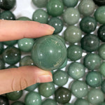 Side view of Aventurine Spheres (Green Quartz) - Wholesale Bulk showing natural crystal details
