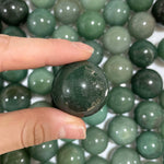 Close-up of Aventurine Spheres (Green Quartz) - Wholesale Bulk with visible color and formation