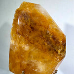 Side view of Golden Healer Free Form With Stand showing natural crystal details