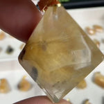 Golden Flowers Rutilated Pendants Lot product video showing Rutile Quartz Pendant - Golden Flowers Rutilated Pendants Lot in bulk from Amezoni.